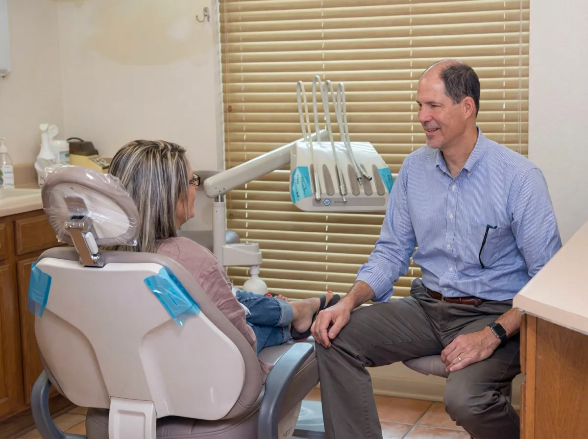 Dentist talking with a patient about treatment