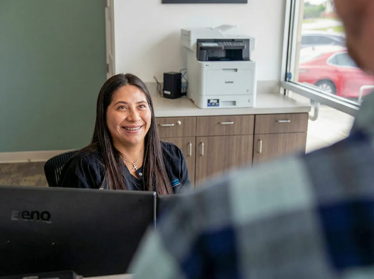 Front desk agent smiling at a patient