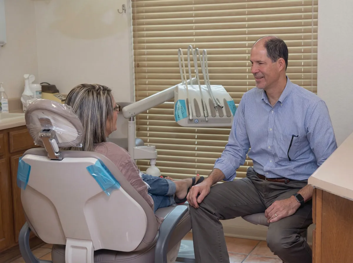 Dentist talking with a patient in the dental chair